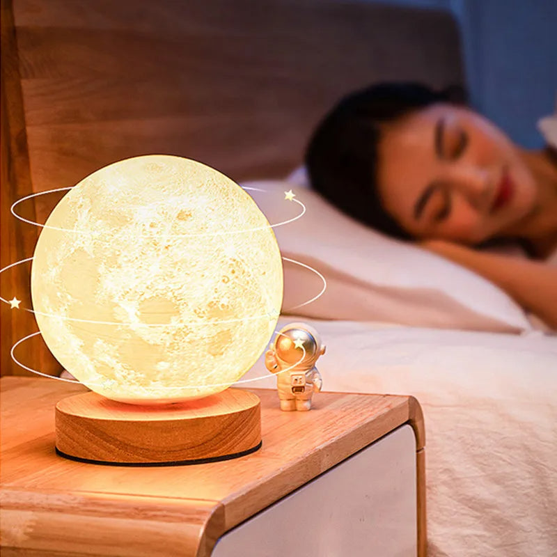 Moon lamp on a bedside table with a person sleeping in the background