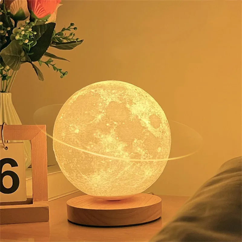 Moon lamp on a wooden base with a decorative plant and calendar in the background